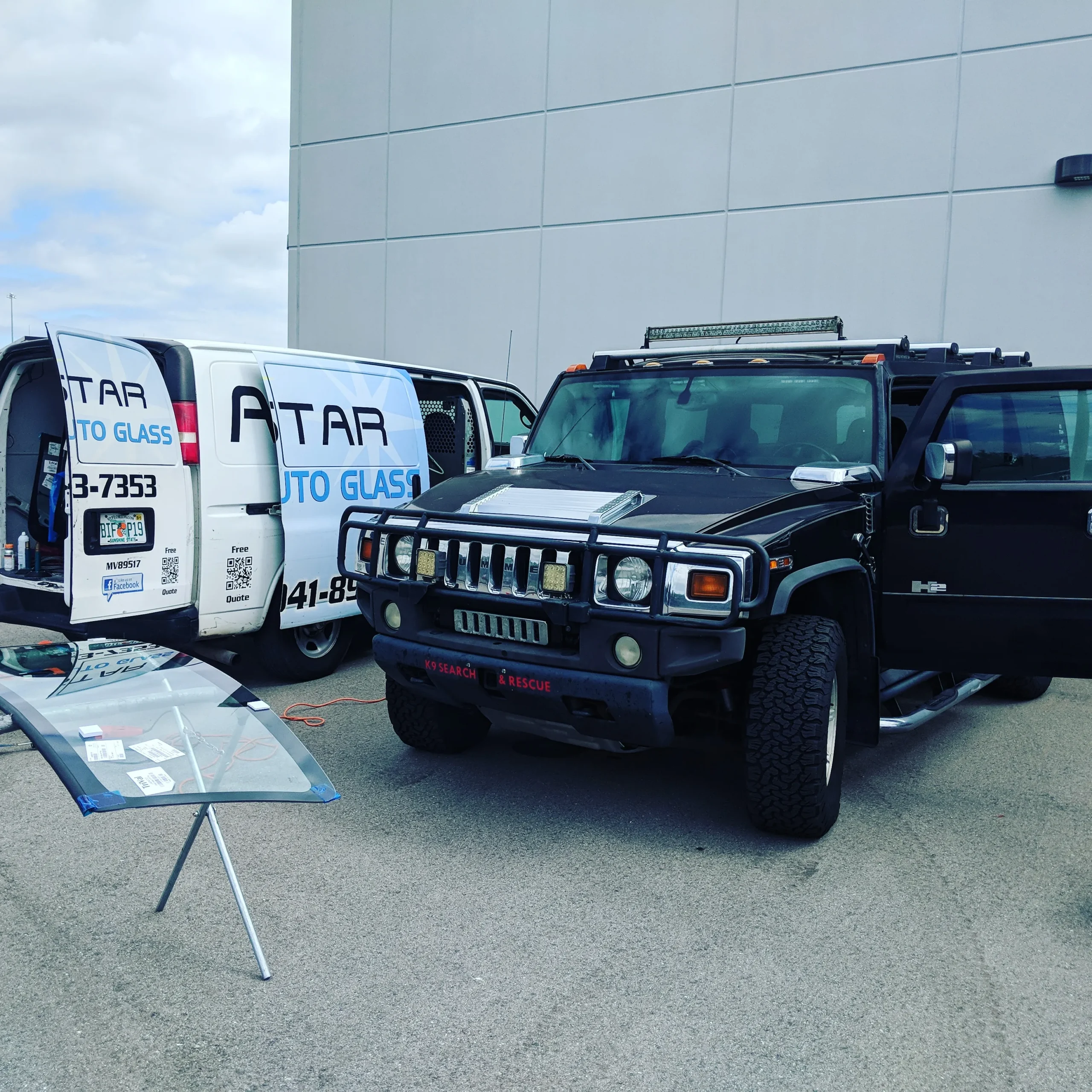 A Star Auto Glass branded service van and vehicle outside the shop in Sarasota FL