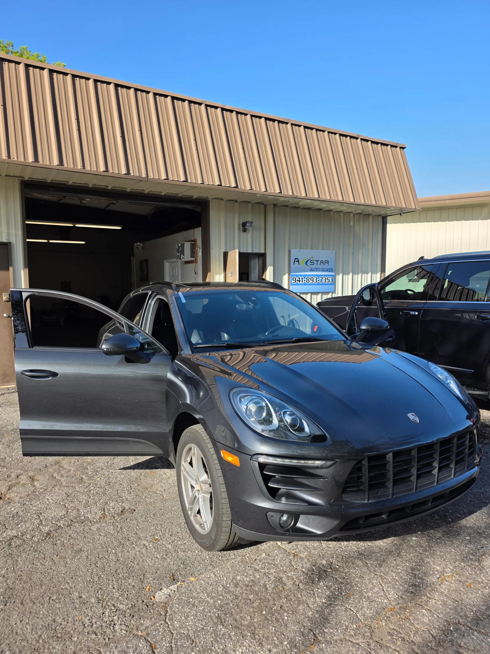 A Star Auto Glass shop exterior at 4023 Sawyer Rd Sarasota FL with customer Porsche vehicle