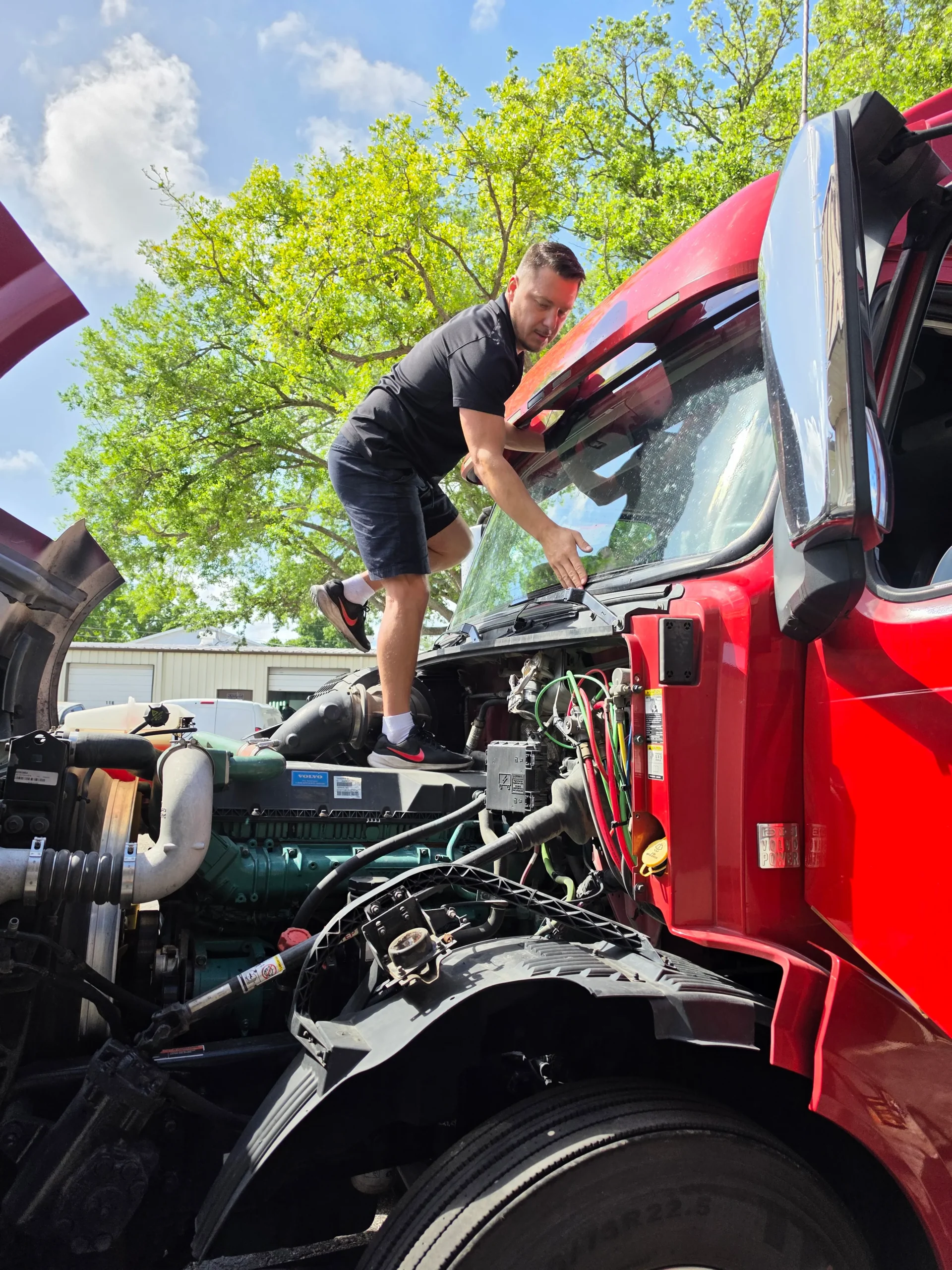 Alex Semencha, owner of A Star Auto Glass, installing a windshield on a commercial truck