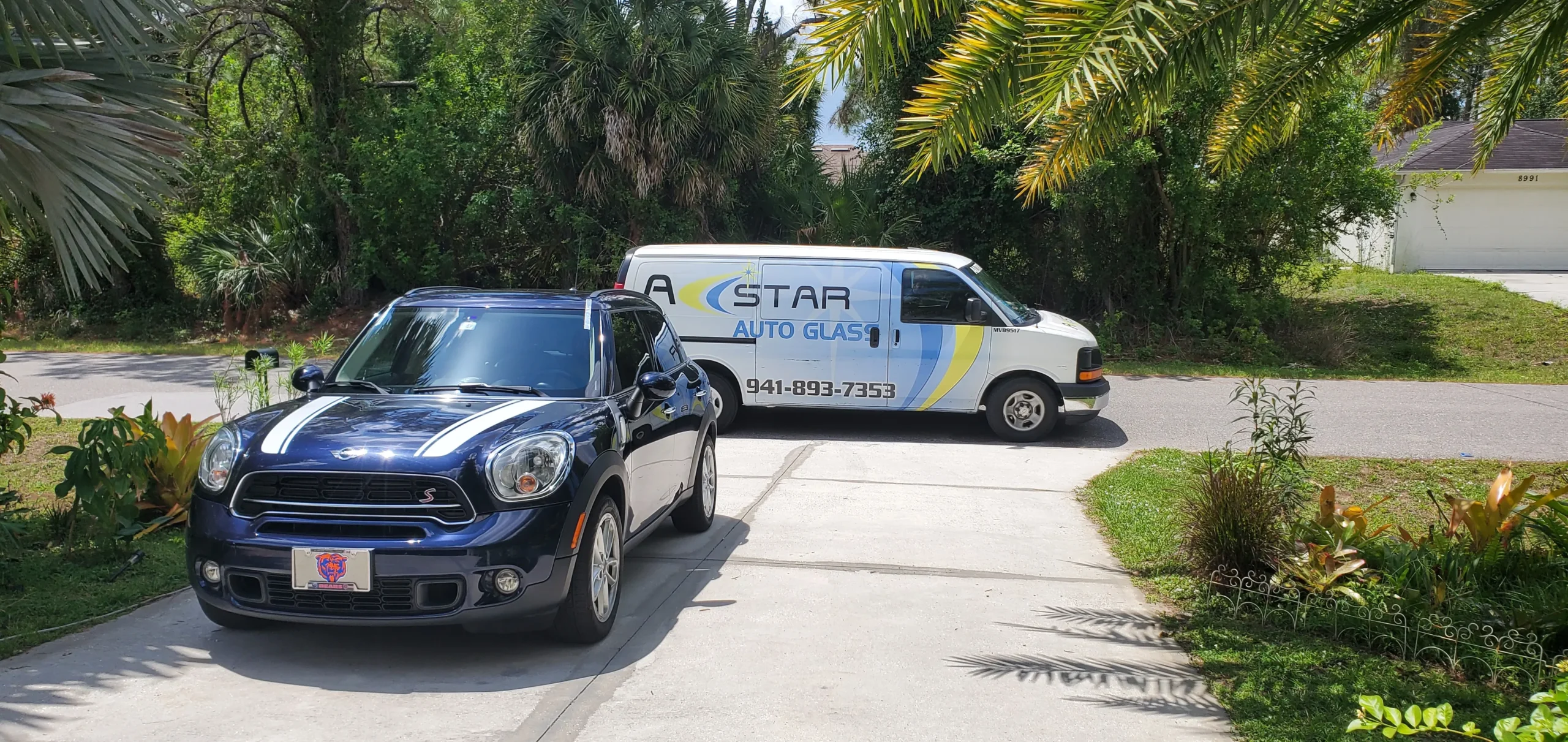 A Star Auto Glass service van at a Bradenton residential driveway for mobile windshield replacement