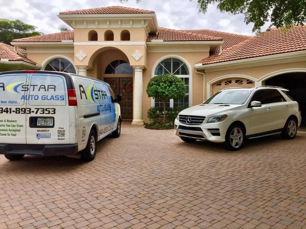 A Star Auto Glass service van parked at a Sarasota home for mobile windshield replacement service