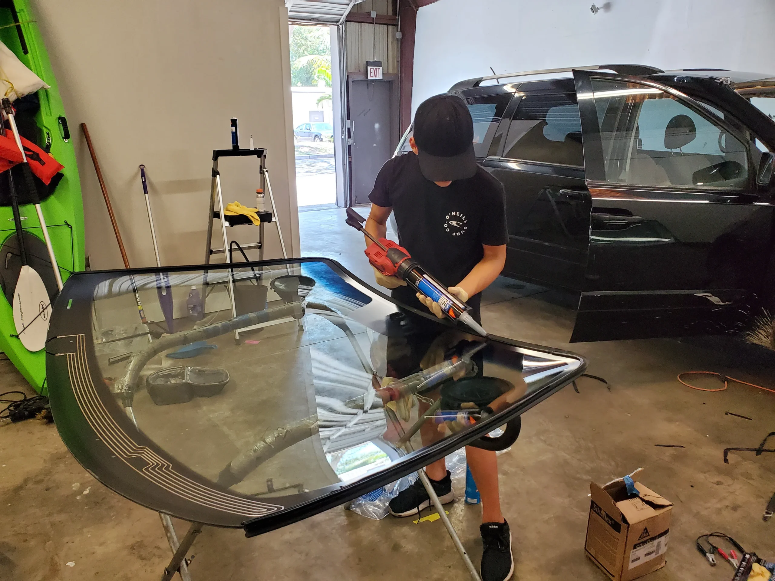 Auto glass technician preparing OEM windshield for installation at A Star Auto Glass Sarasota FL